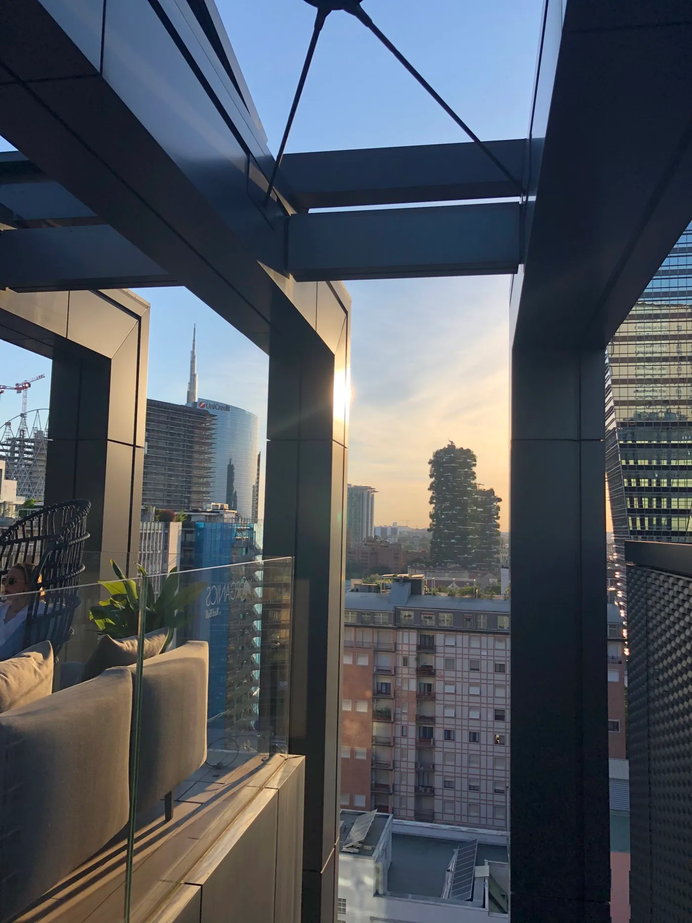 Sunset over the Porta Nuova skyscrapers and the Bosco Verticale seen from the Organics SkyGarden rooftop