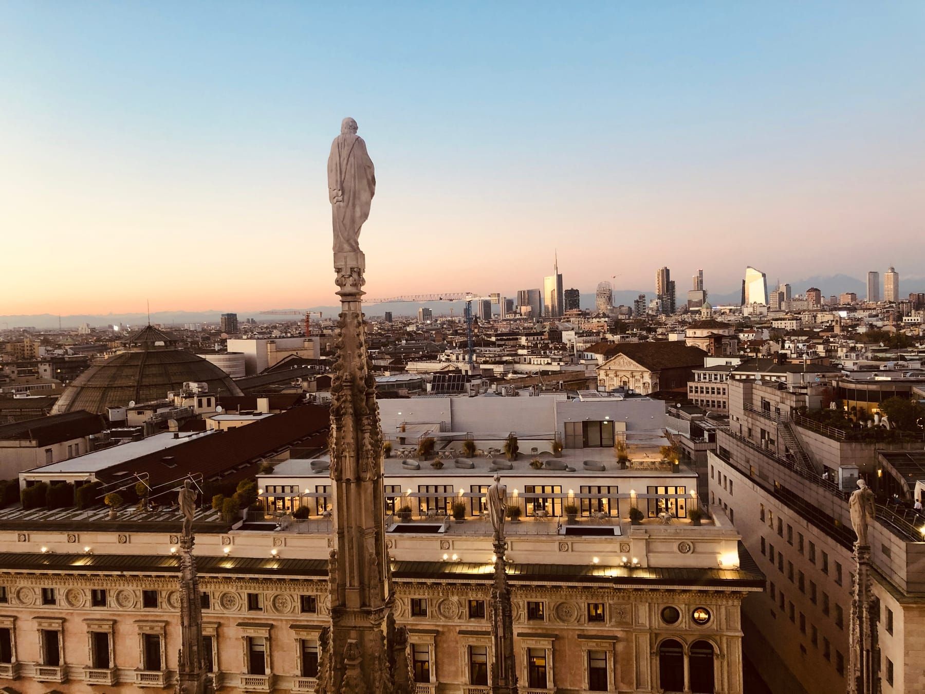 The rooftops of Milan seen from the spires of the Duomo, with the Porta Nuova skyscrapers on the horizon