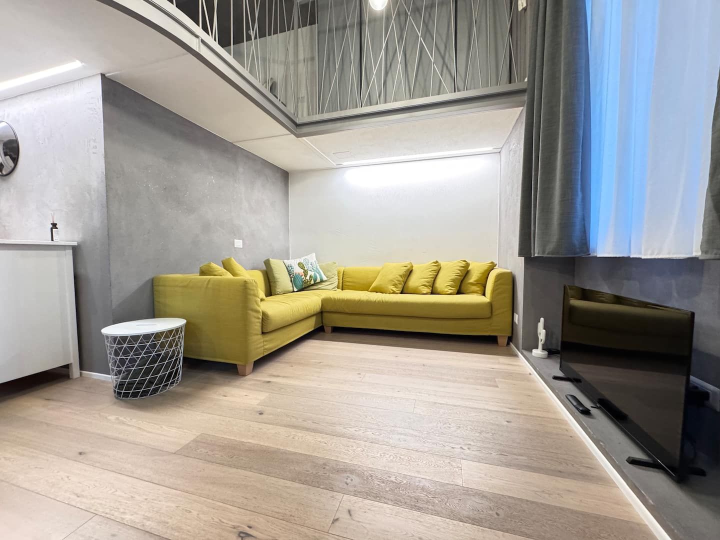 Loft living area with sofa and TV
