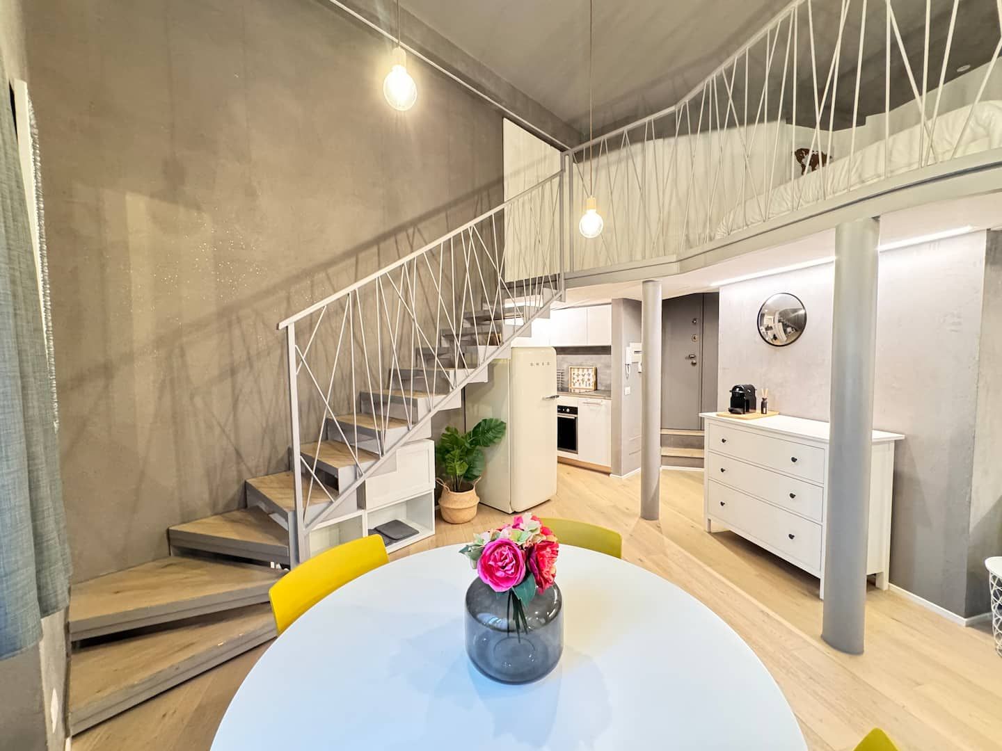 Staircase to the mezzanine and dining table