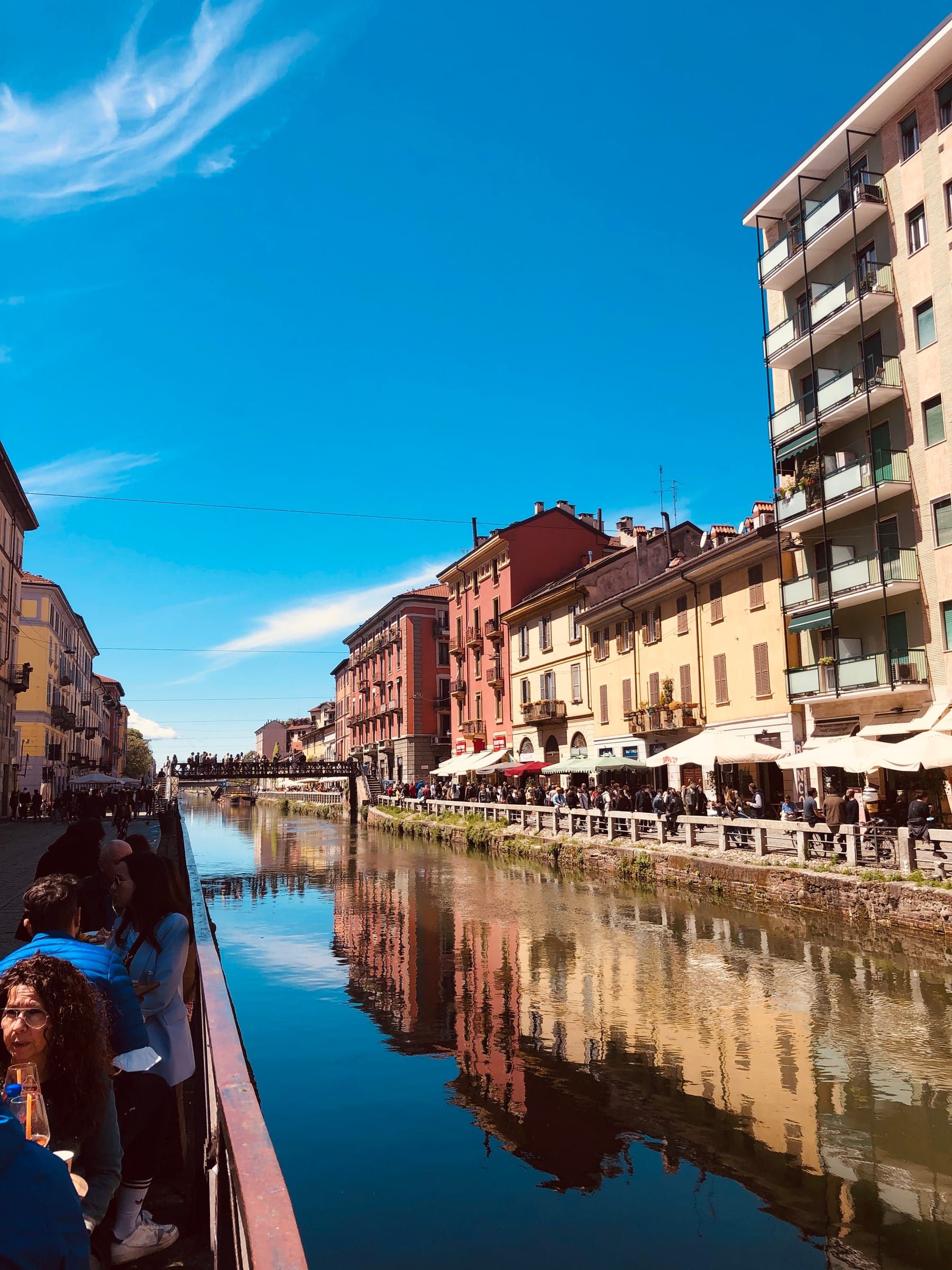 Naviglio Grande from the bridge, with the tables of bars reflected in the water